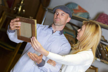 mature couple buying a painting at auctionの写真素材