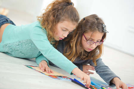 Two young girls drawingの写真素材