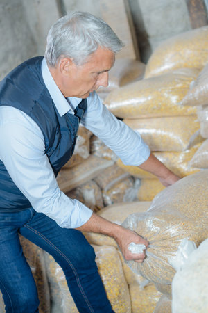 Man shifting bag of grain
