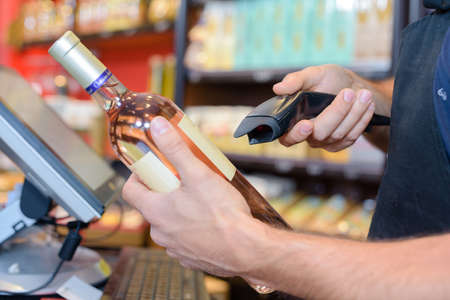 scanning a bottle of liquorの写真素材