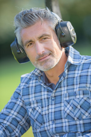 Portrait of middle aged man wearing earmuffsの写真素材