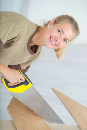 woman cutting a plywoodの写真素材