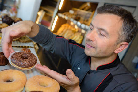 proud pastry chef in his confectionneryの写真素材