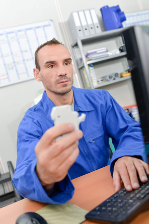 Electrician sat at his deskの写真素材