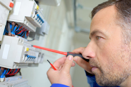 Man wiring fuse into box