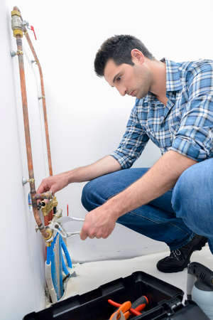 Man connecting pipesの写真素材