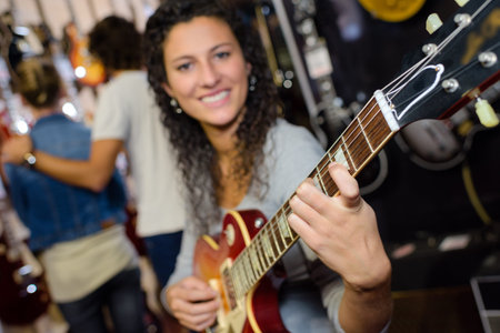 young woman playing a guitar