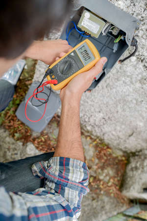 Electrician using a voltmeterの写真素材