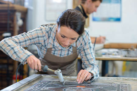 Woman working with stained glassの写真素材