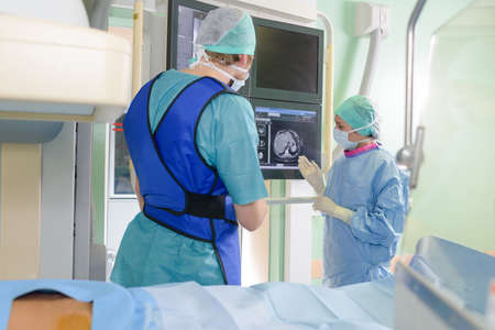 Surgeons consulting image on screenの写真素材