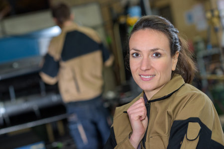 happy factory employee posing in the workshop