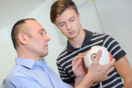 ophthalmologist holding an eye model