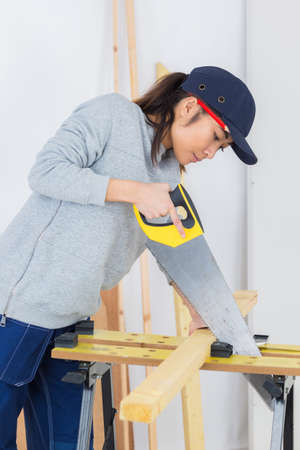 Asian lady using handsawの写真素材