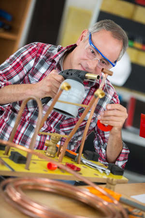 worker using a blowtorchの写真素材