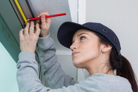 Woman marking point on window