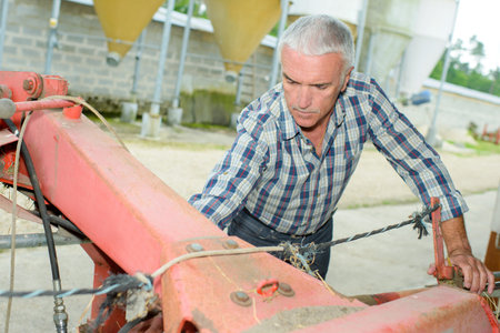 Farmer working on machineryの写真素材