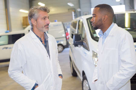 Two paramedics in vehicle depotの写真素材