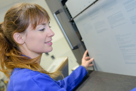 Woman aligning paper in machine
