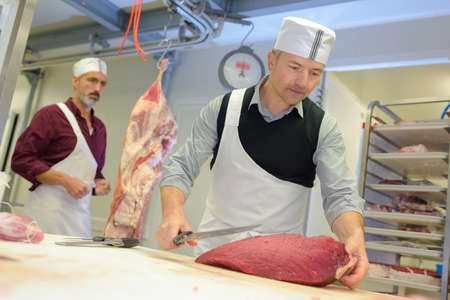 cutting a piece of meatの写真素材