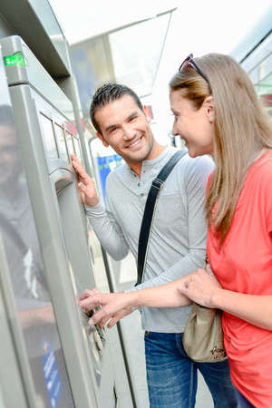 Couple buying a ticket to ride the tramの写真素材