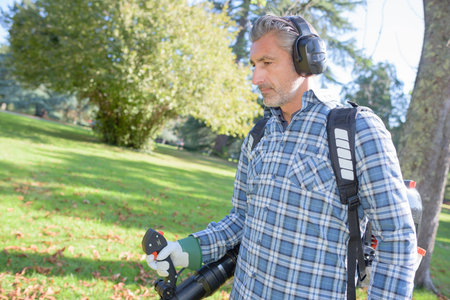 garden worker using a leaf blower