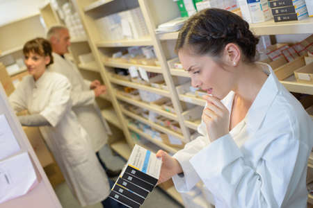 pharmacist reading the labelの写真素材