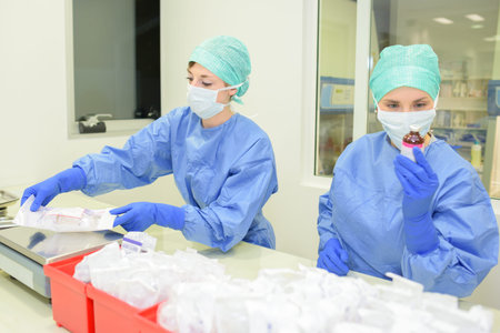 pharmacists preparing ingredients for pills