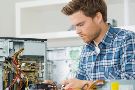 handsome computer engineer repairing a faulty pc