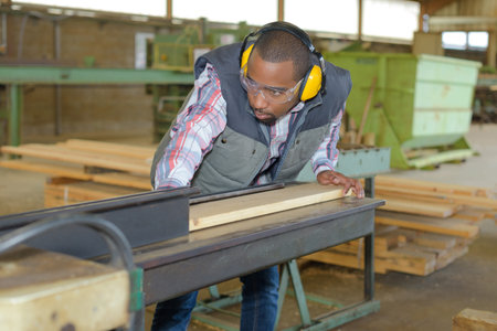 Man feeding wood into machine