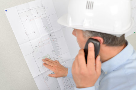 Architect checking plans with client over the phone