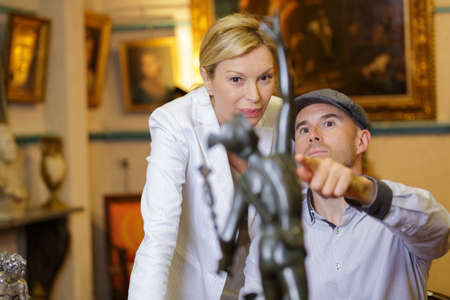 woman and man looking for antiques at flea marketの写真素材
