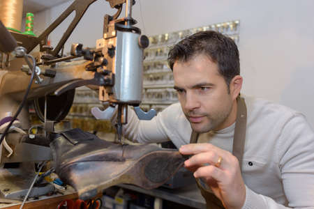 cobbler repairing a shoeの写真素材