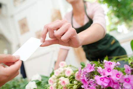Florsit holding a buiness cardの写真素材