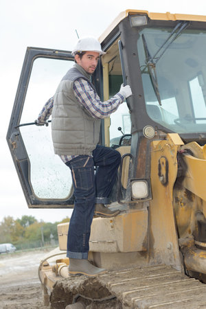 worker aboard a bulldozer