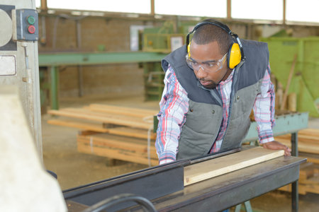 Worker planing wood