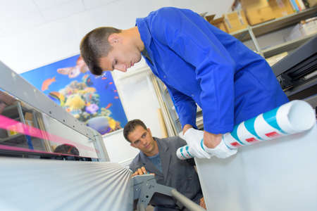 advertising business employees rolling paperの写真素材