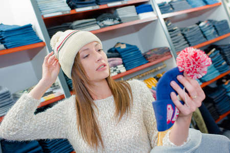 Woman shopping for a hatの写真素材