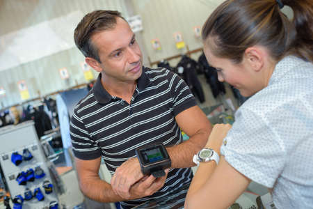 Man and woman looking at finess watchesの写真素材