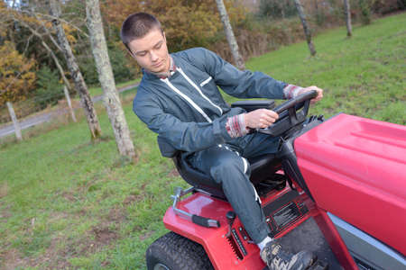 Man maneuvering mowerの写真素材