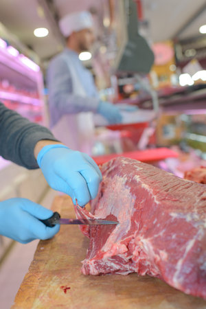Closeup of meat being cut up