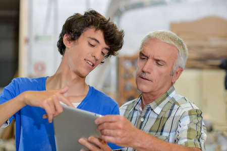 Carptenters using tablet computerの写真素材