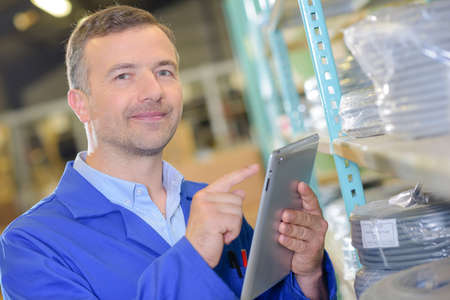 worker using a tablet to store informationの写真素材