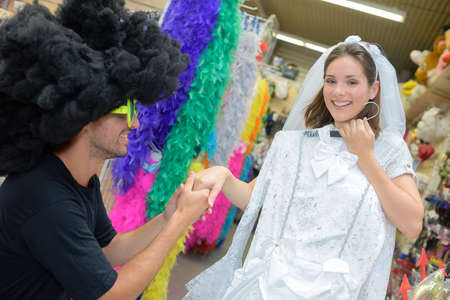 portrait of happy couple having fun trying costumesの写真素材