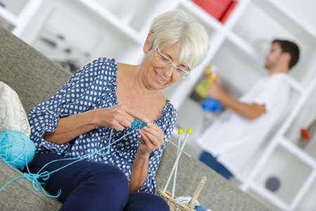 senior woman knitting at homeの写真素材