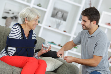 young helpful grandson spending time with grandmotherの写真素材