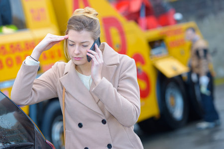 woman having car problems and calling for assistance