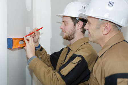 teacher helping students training to be buildersの写真素材