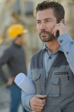 engineer with cell phone on the construction siteの写真素材