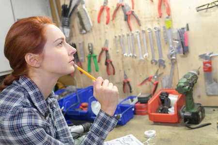 redhead woman in her workshopの写真素材