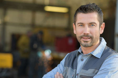 confident supervisor outside warehouseの写真素材